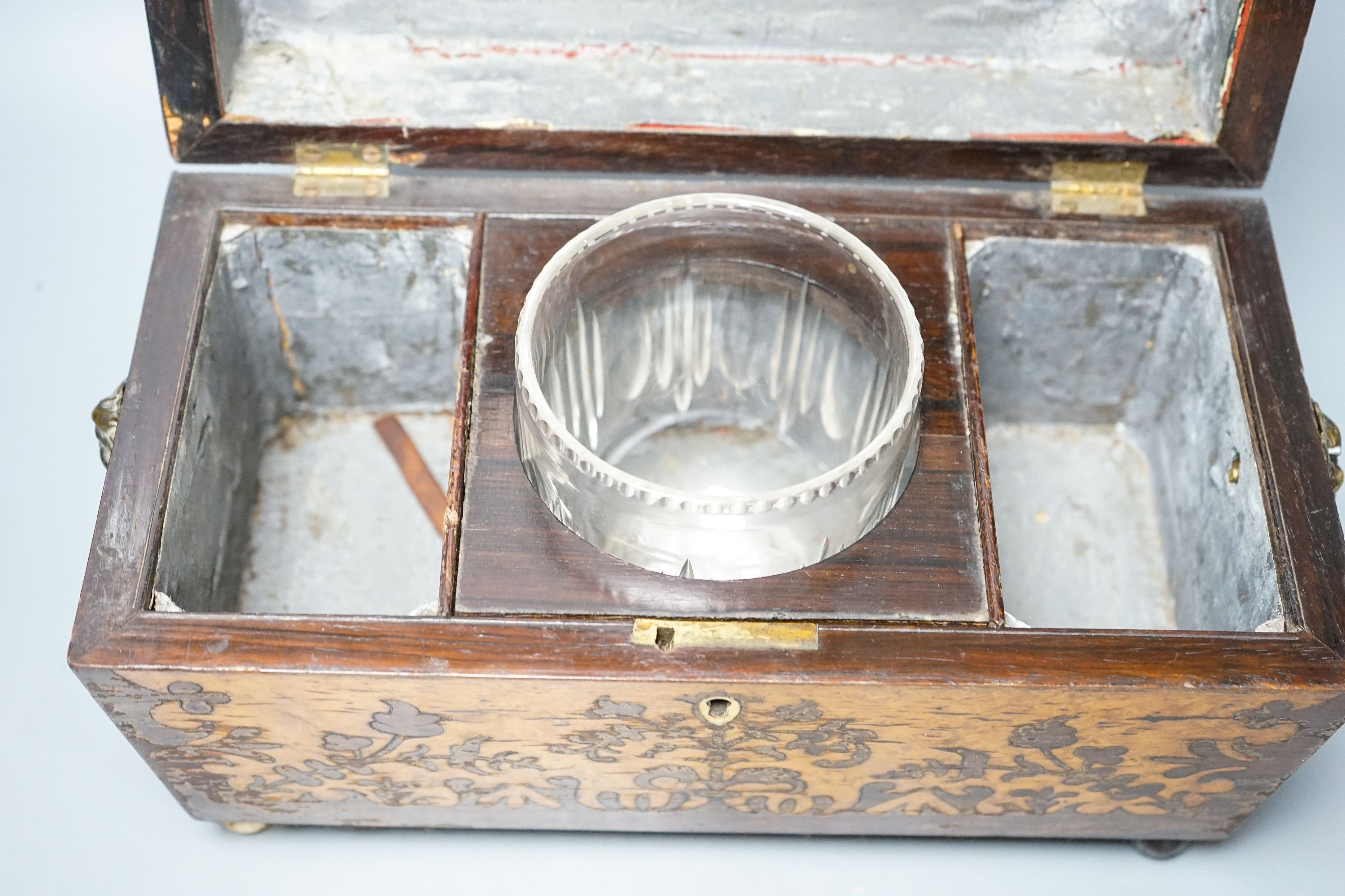 A 19th century rosewood and bird’s eye maple tea caddy, of sarcophagus form, the interior with mixing bowl, on ball feet 31cm